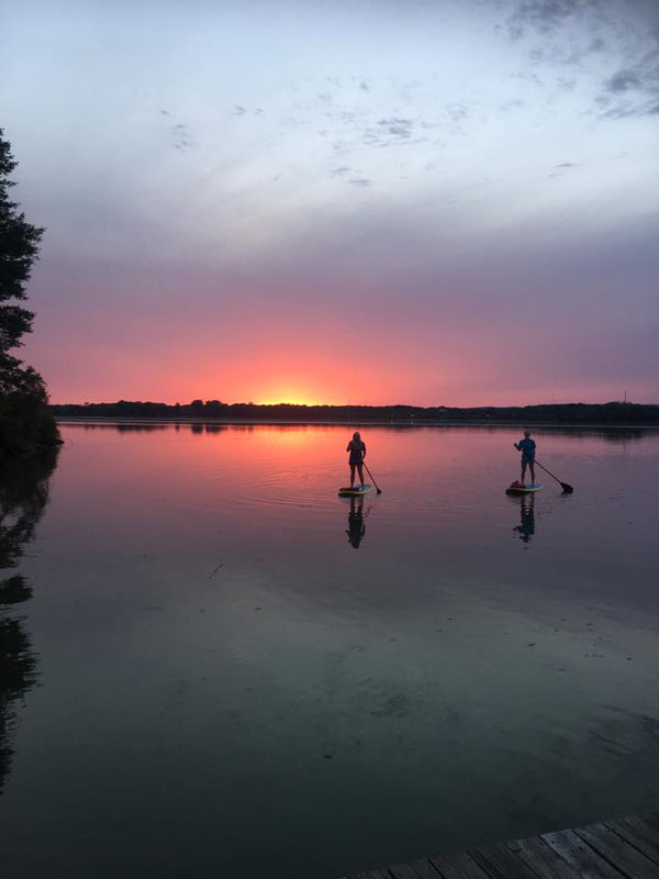 paddle boards at sunset