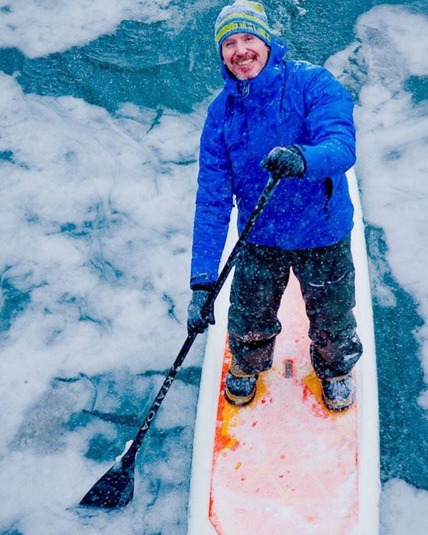 paddle boarding on frozen lake