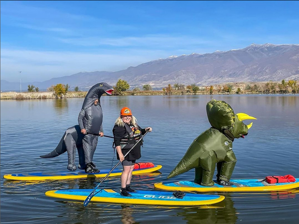 people in costume on paddle boards