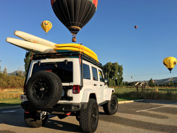 paddleboards on a jeep roof