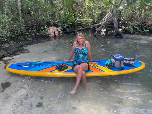 woman sitting on paddleboard