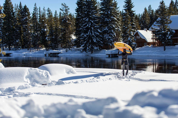 carrying a paddle board in snow