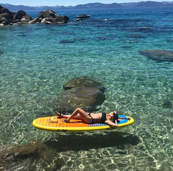 woman lying on sup board in tahoe